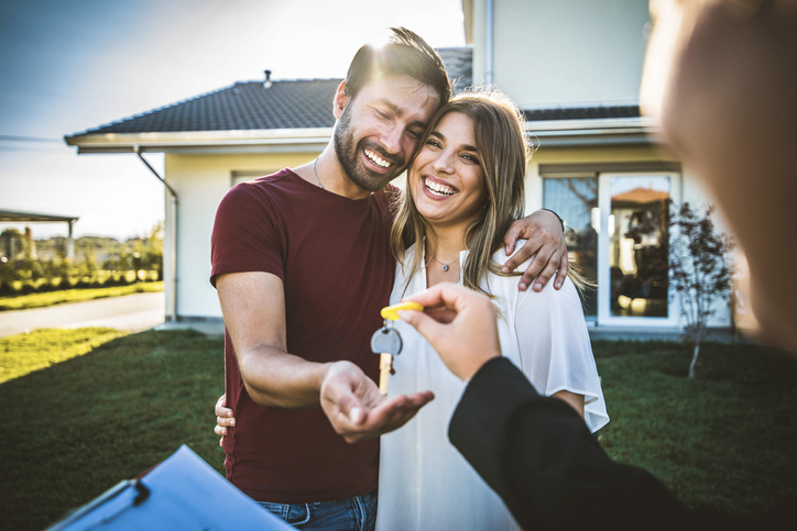 First-time home buyers receiving the keys to their new home
